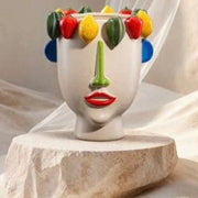 Jarron con cara y frutas blanco y colores